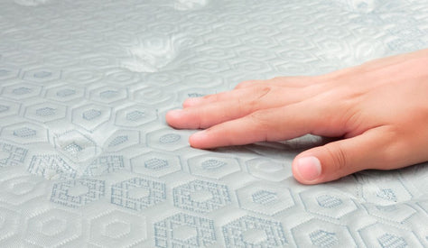 Hand touching CoolTech technology cooling mattress